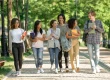 Happy young students walking outdoors